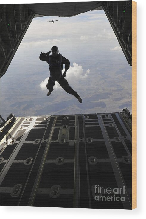 Exercise Carpathian Spring Wood Print featuring the photograph A Paratrooper Salutes As He Jumps by Stocktrek Images