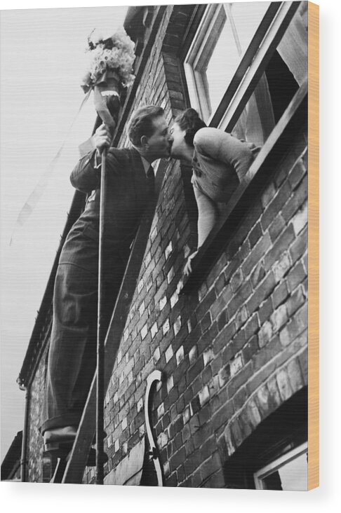 1950-1959 Wood Print featuring the photograph Climbing Up For A Kiss In England On by Keystone-france