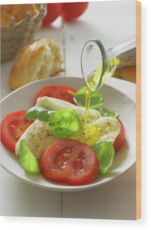 Caprese Salad Wood Print featuring the photograph Olive Oil Pouring On Caprese Salad In by Westend61