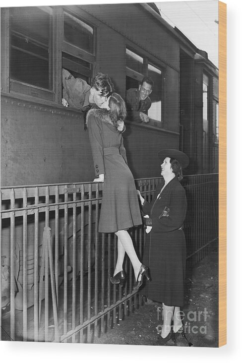 People Wood Print featuring the photograph Soldier Kissing Girlfriend Goodbye by Bettmann