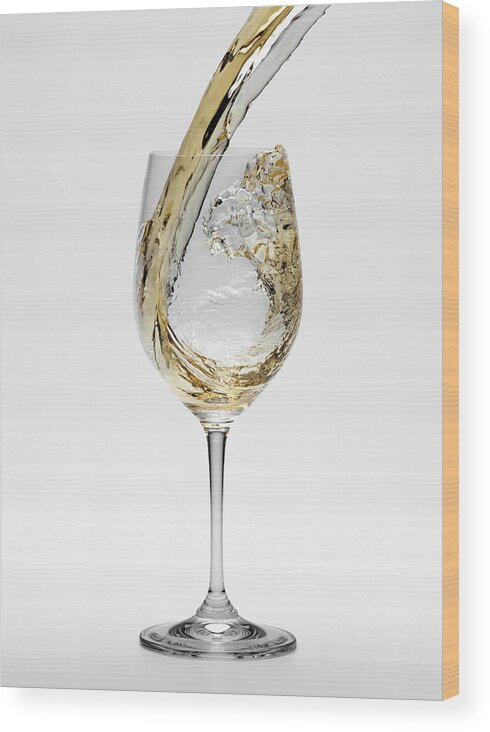 White Background Wood Print featuring the photograph White Wine Being Poured Into Wineglass by Don Farrall