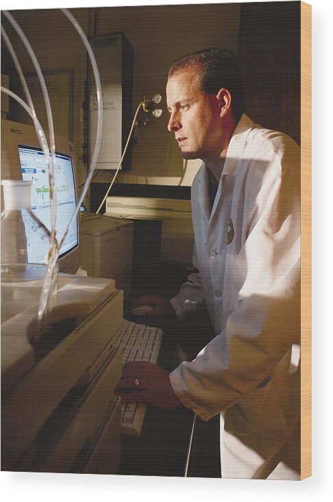 Problems Wood Print featuring the photograph A Caucasian Chemist Analyzes Data On A Computer Screen While Standing In A Laboratory by Photodisc