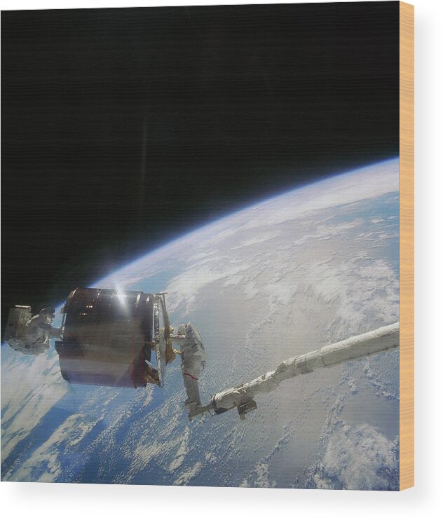 Shuttle Imagery Wood Print featuring the photograph Retreival Of Damaged Communications Satellite. by Nasa/science Photo Library.