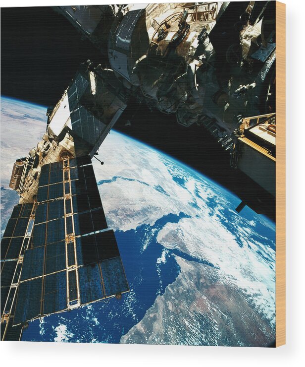 Square Wood Print featuring the photograph A Satellite Orbiting Above The Earth #1 by Stockbyte
