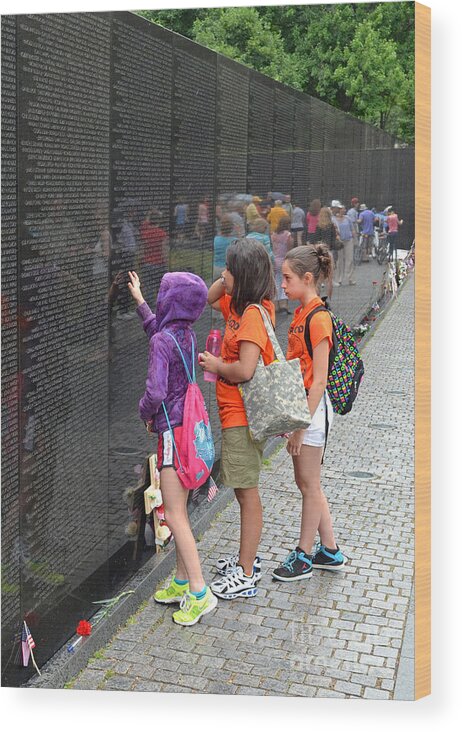 Vietnam Veterans Memorial Wood Print featuring the photograph Searching a loved Ones Name on the Vietnam Veterans Memorial by Jim Fitzpatrick