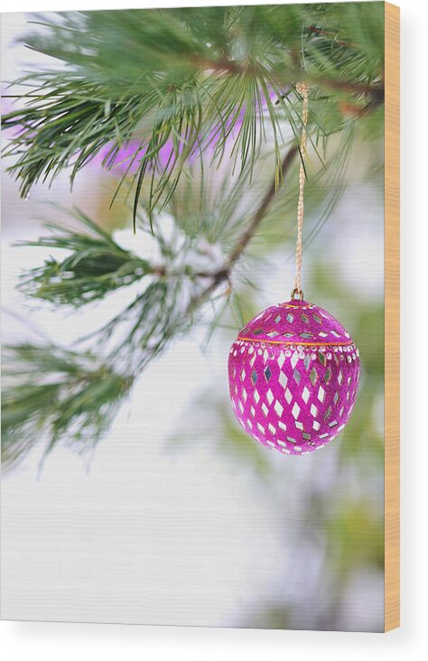 Christmas Wood Print featuring the photograph Pink Christmas ornament on snowy pine tree branch by Marianne Campolongo