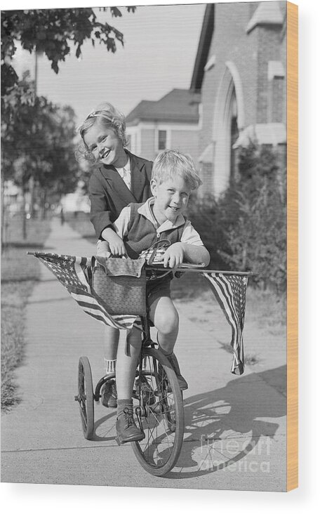 Child Wood Print featuring the photograph Boy And Girl 8-9 Years Riding Bicycle by Bettmann
