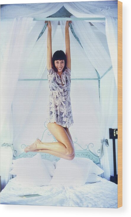 Beauty Wood Print featuring the photograph Christy Turlington Hanging From A Canopy Bed by Arthur Elgort