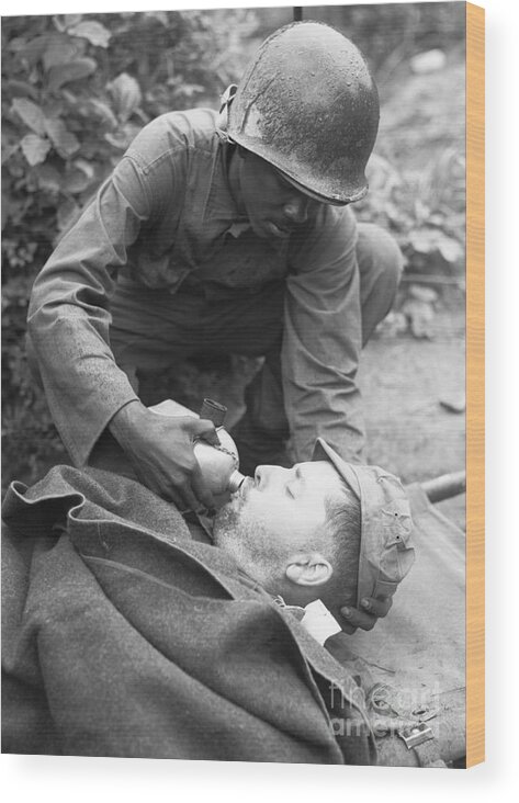 Korea Wood Print featuring the photograph Medic Lowers Canteen To Lips Of Soldier by Bettmann