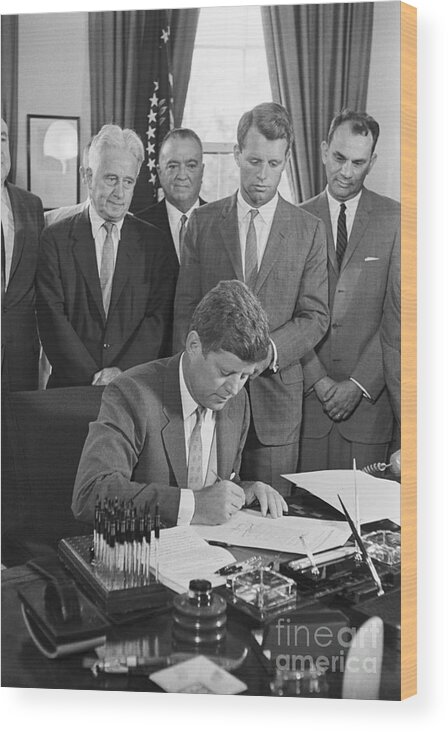 Mature Adult Wood Print featuring the photograph President John F. Kennedy Signs by Bettmann