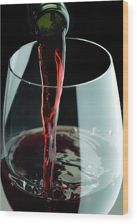 Alcohol Wood Print featuring the photograph Red Wine Being Poured In A Glass by Juanmonino