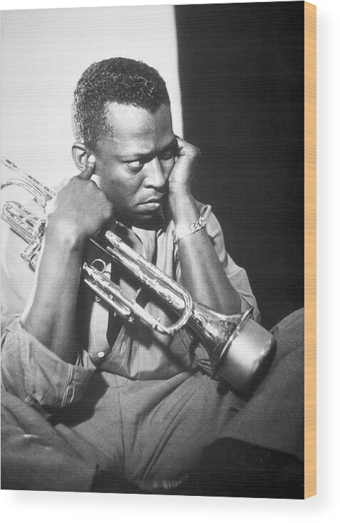 Miles Davis Wood Print featuring the photograph Jazz trumpeter Miles Davis early in his career playing in New York City, circa 1955. by Album