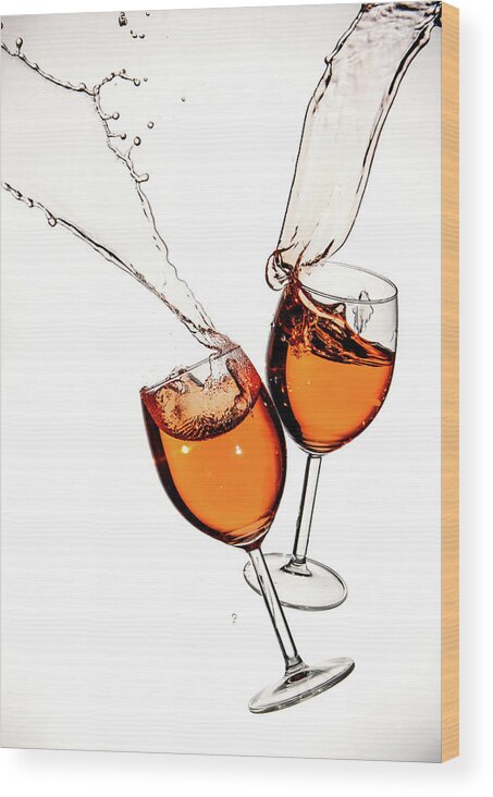 Alcohol Wood Print featuring the photograph Red wine in glasses with splashes on a white background isolated by Michalakis Ppalis