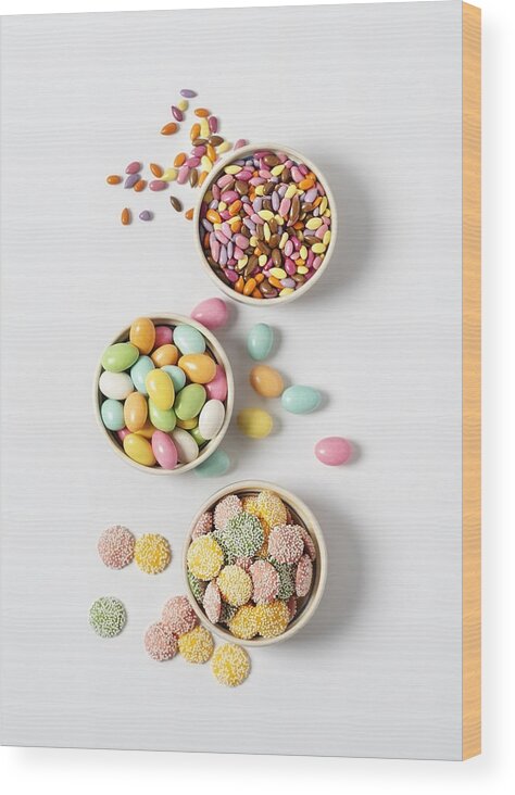 Unhealthy Eating Wood Print featuring the photograph Variety of candy in bowls on white background by Claudia Totir