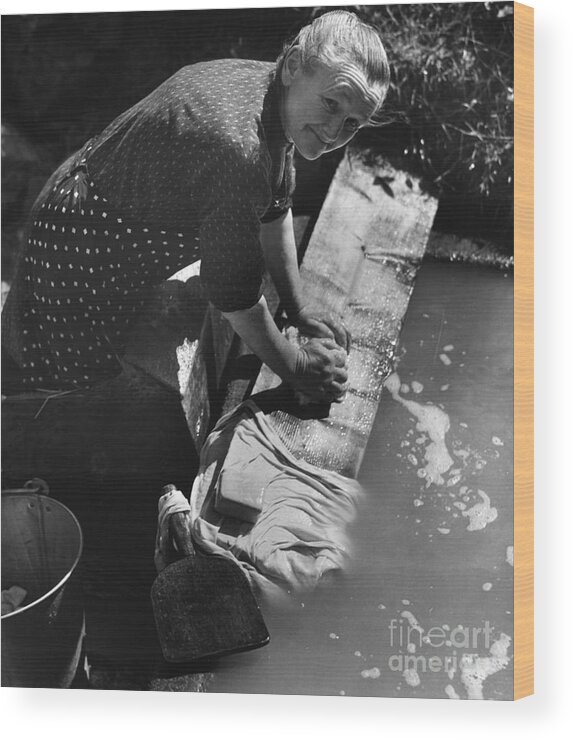 Farm Worker Wood Print featuring the photograph French Peasant Woman Doing Her Laundry by Bettmann
