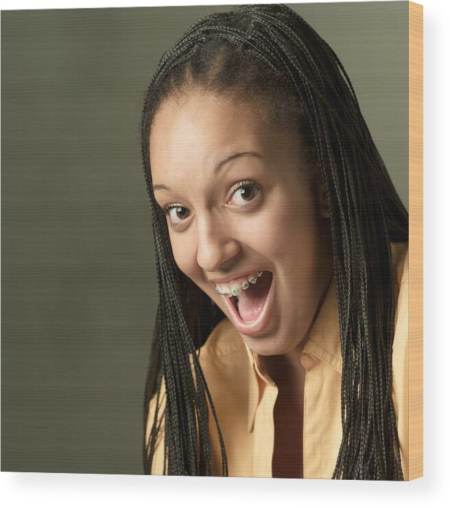 Portrait Of A Teenage African American Girl In An Orange Shirt As She Opens Her Mouth In Surprise And Smiles Wood Print