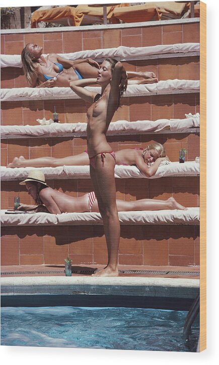 1980-1989 Wood Print featuring the photograph Sunbathing On Capri by Slim Aarons