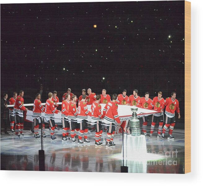 Blackhawks Banner Raising Wood Print featuring the photograph Chicago Blackhawks and the Banner by Melissa Jacobsen