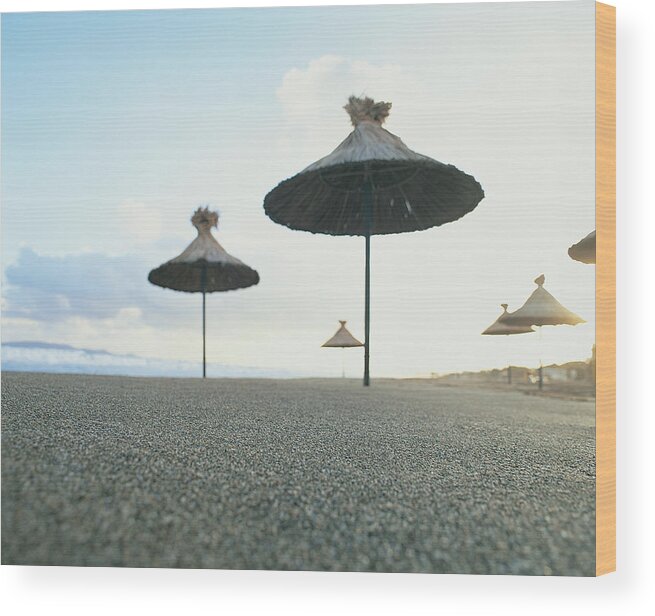 Bamboo Wood Print featuring the photograph Bamboo Parasols On An Empty Beach, Crete by Allan Baxter