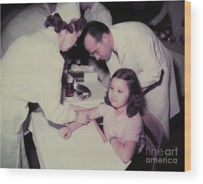 Polio Wood Print featuring the photograph Girl Receiving Polio Vaccine From Jonas by Bettmann