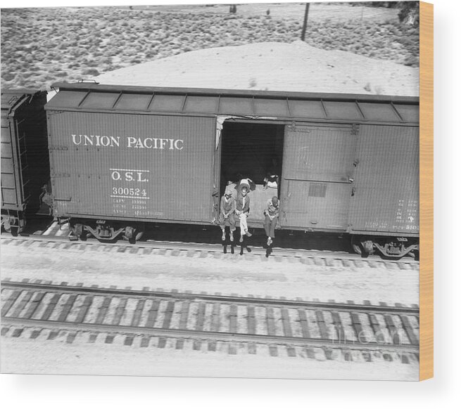 Hanging Wood Print featuring the photograph Hobos Riding Freight Car To California by Bettmann
