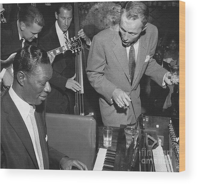 Singer Wood Print featuring the photograph Nat King Cole Playing With Frank Sinatra by Bettmann
