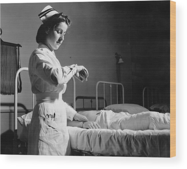 People Wood Print featuring the photograph Nurse Takes Pulse by Three Lions