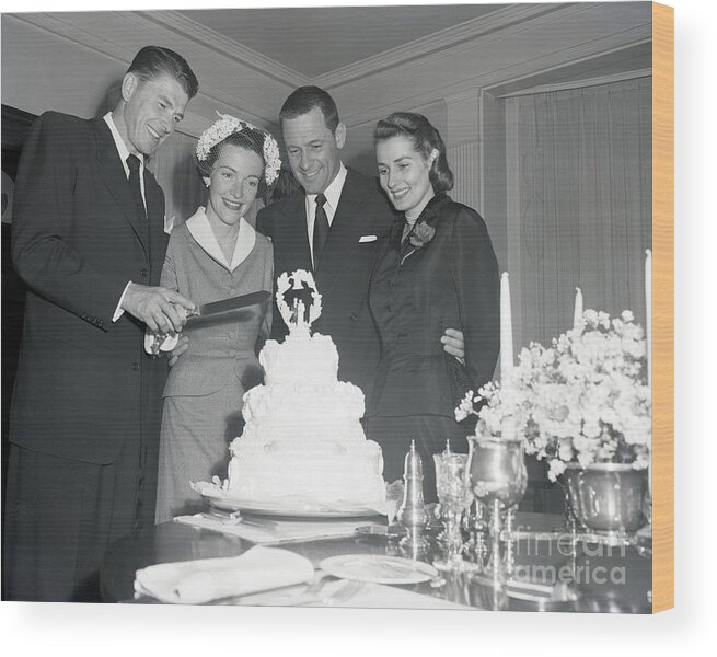 Bridegroom Wood Print featuring the photograph Ronald And Nancy Reagan Slicing Wedding by Bettmann