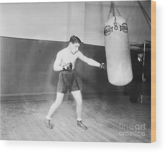 Young Men Wood Print featuring the photograph Tuffy Griffith Working The Weight Bag by Bettmann