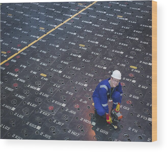 Working Wood Print featuring the photograph Engineer using sensors on pile cap in nuclear power station, portrait by Monty Rakusen
