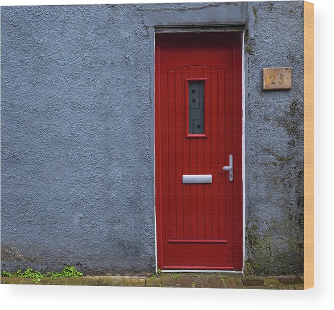 Red Door Wood Print featuring the photograph Traditional English house facade front entrance with red closed door . by Michalakis Ppalis