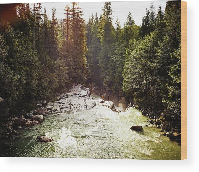 Tranquility Wood Print featuring the photograph Group Of Friends Standing On Rock Above by Thomas Barwick