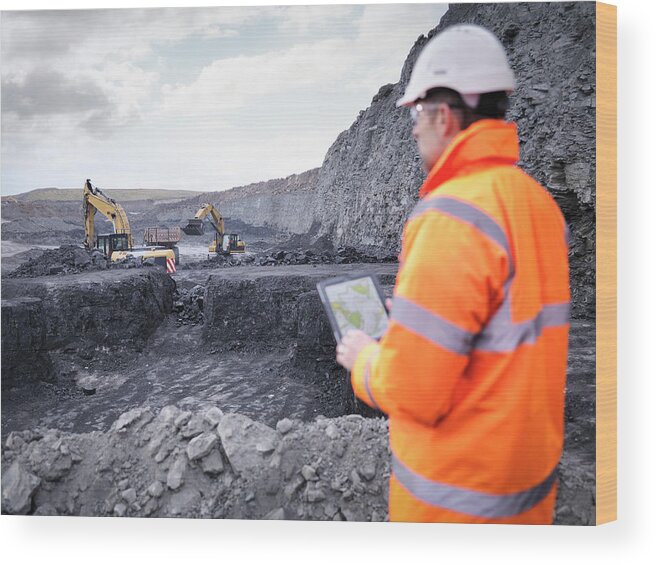 Working Wood Print featuring the photograph Miner Checks Plans On Digital Tablet In by Monty Rakusen
