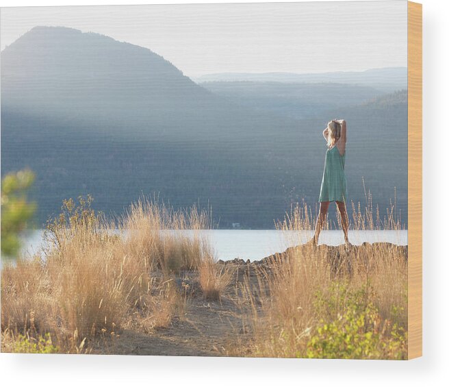 Woman Wood Print featuring the photograph Woman Stretches In Grasses Above Lake by Philip & Karen Smith / TFA