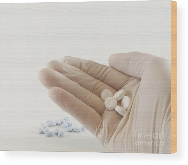 Hand Wood Print featuring the photograph Hand with pills by Blink Images