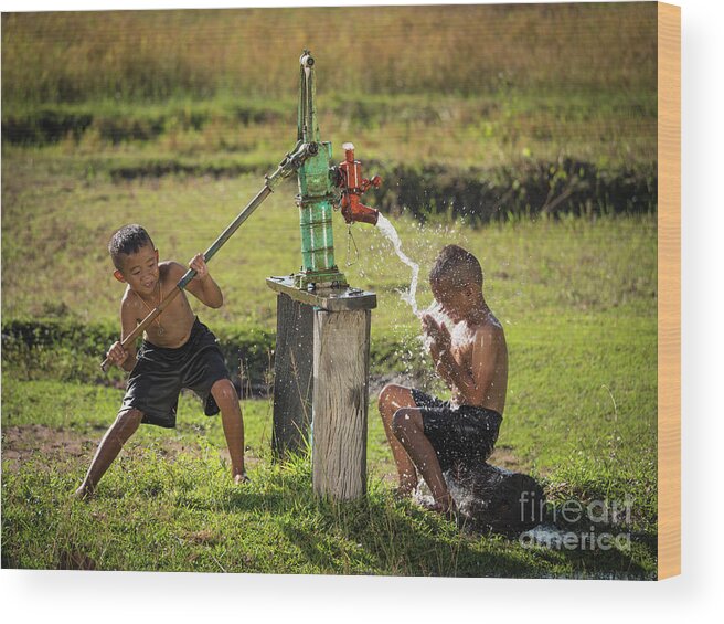 Sun Wood Print featuring the photograph Two young boy rocking groundwater bathe in the hot days. #2 by Tosporn Preede