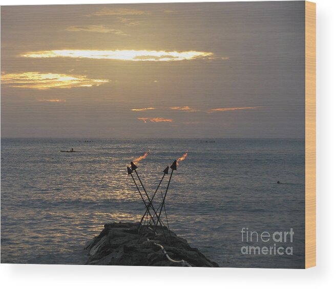 Tiki Torches On The Waters Edge In Waikiki Wood Print featuring the photograph Tiki Torches in the Sunset by Anthony Trillo