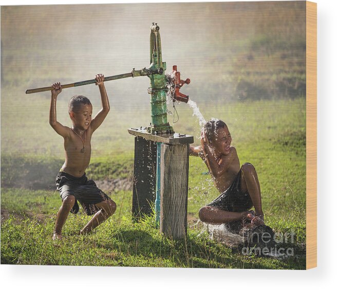 Sun Wood Print featuring the photograph Two young boy rocking groundwater bathe in the hot days. by Tosporn Preede