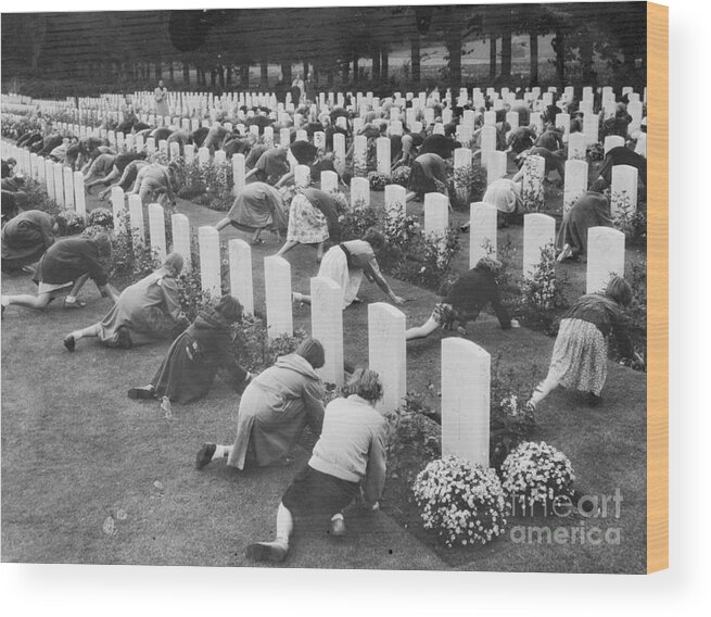 Child Wood Print featuring the photograph Children Placing Flowers On Graves by Bettmann
