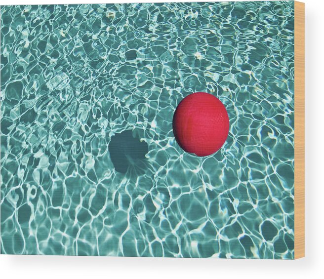 Tranquility Wood Print featuring the photograph Floating Red Ball In Blue Rippled Water by Mark A Paulda