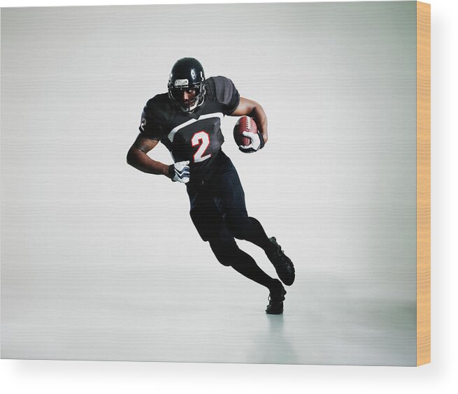 American Football Uniform Wood Print featuring the photograph Football Player Running With Ball by Thomas Barwick