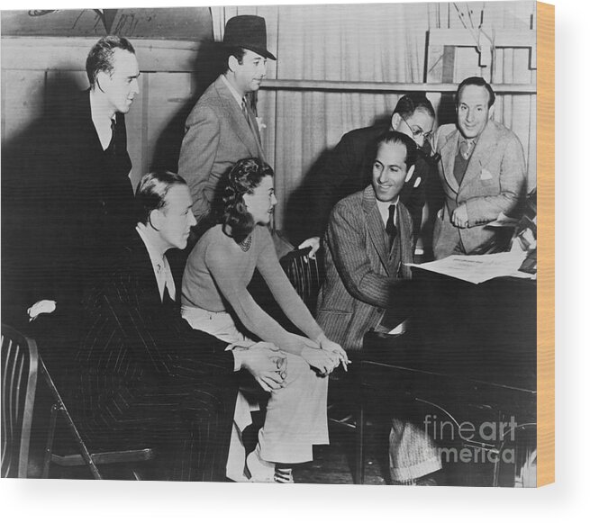 Piano Wood Print featuring the photograph George Gerswhin Playing Piano On Set by Bettmann
