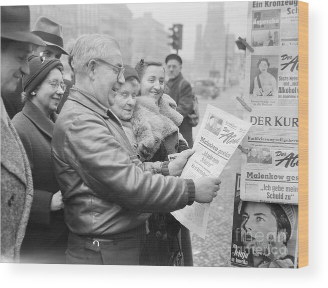 Mature Adult Wood Print featuring the photograph Group Reading Newspaper by Bettmann