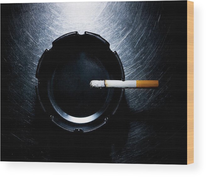 Part Of A Series Wood Print featuring the photograph Lit Cigarette And Ashtray On Stainless by Ballyscanlon