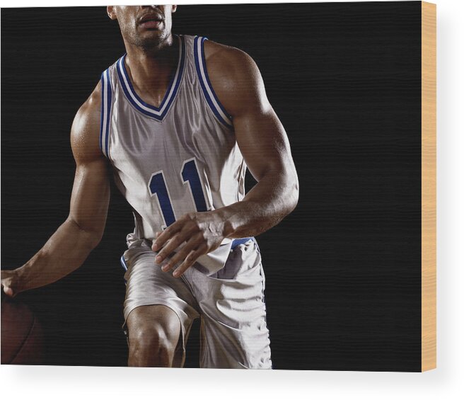 Three Quarter Length Wood Print featuring the photograph Mixed Race Basketball Player Bouncing by Patrik Giardino