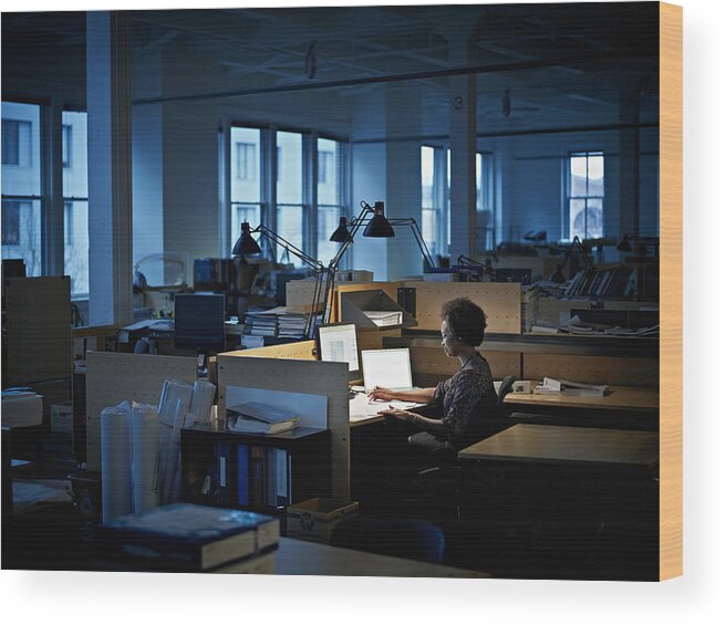 Expertise Wood Print featuring the photograph Businesswoman examining documents at desk at night by Thomas Barwick