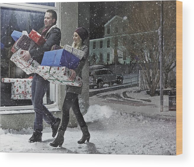 Mid Adult Wood Print featuring the photograph Couple with Christmas gifts in snow by KMM Productions
