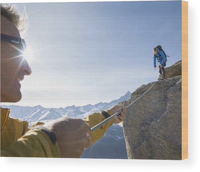 Young Men Wood Print featuring the photograph Mountaineer pulls rope tight to teammate, mtns by Ascent Xmedia