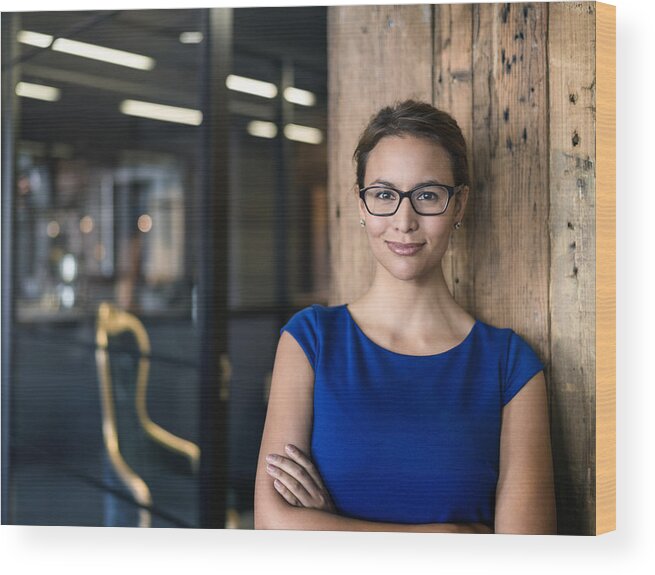 Expertise Wood Print featuring the photograph Portrait of confident businesswoman in office by Portra