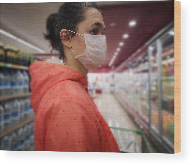 People Wood Print featuring the photograph Young woman wears medical mask against virus while grocery shopping in supermarket, by Oonal